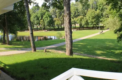 a view of a park with trees and a path at Vila Klasika in Birštonas