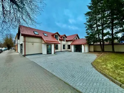 a house with a red roof and a driveway at Centro apartamentai in Radviliškis