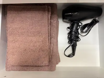 a hair dryer and a black hair dryer at Centro apartamentai in Radviliškis