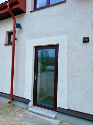 a glass door on the side of a building at Centro apartamentai in Radviliškis
