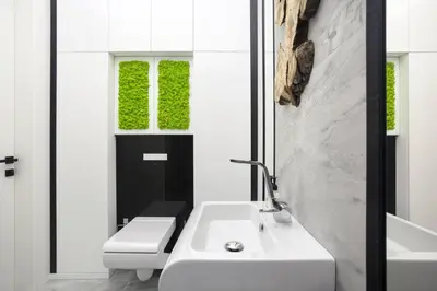 a white bathroom with a sink and a toilet at Modern White Moss Apartment Kaunas Center in Kaunas