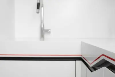 a counter top with a red arrow on it at Modern White Moss Apartment Kaunas Center in Kaunas