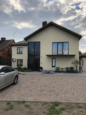 a house with a car parked in front of it at Florina namai 2 in Marijampolė