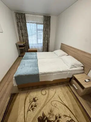 a bedroom with a large bed and a window at Florina namai 2 in Marijampolė