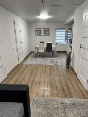 an empty living room with a table and chairs at Florina namai 2 in Marijampolė