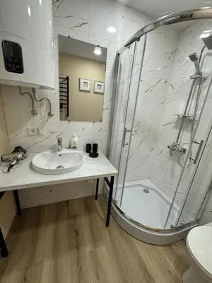a bathroom with a sink and a shower at Florina namai 2 in Marijampolė