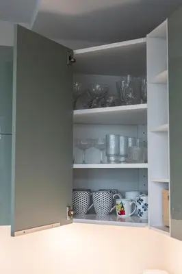 a cupboard filled with lots of dishes at Spacious and Modern Apartment with Free Parking in Vilnius
