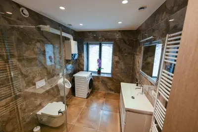 a bathroom with a shower and a toilet and a sink at Valdau NT in Kaunas