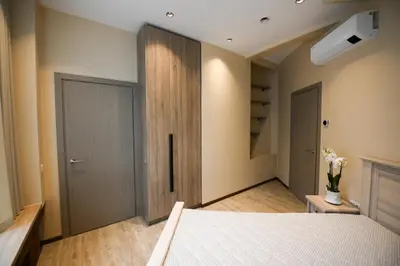 a bedroom with a bed and a closet and a door at Valdau NT in Kaunas