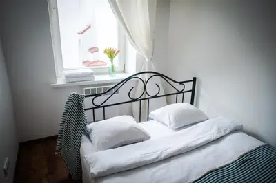 a bed with white pillows in a room with a window at V 18 - Superior & Great views to Vokieciu street in Vilnius