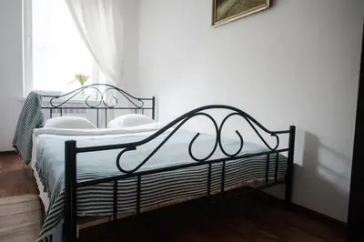a bedroom with two metal beds in a room at V 18 - Superior & Great views to Vokieciu street in Vilnius