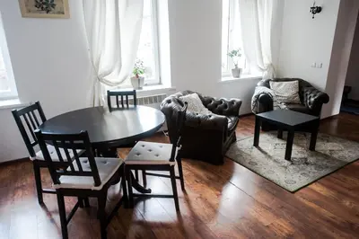a living room with a table and chairs and a couch at V 18 - Superior & Great views to Vokieciu street in Vilnius