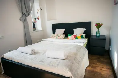 a bedroom with two beds with towels on them at V 18 - Superior & Great views to Vokieciu street in Vilnius