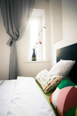 a bedroom with a bed with a window and a pillow at V 18 - Superior & Great views to Vokieciu street in Vilnius
