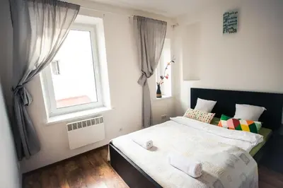 a small bedroom with a bed and a window at V 18 - Superior & Great views to Vokieciu street in Vilnius