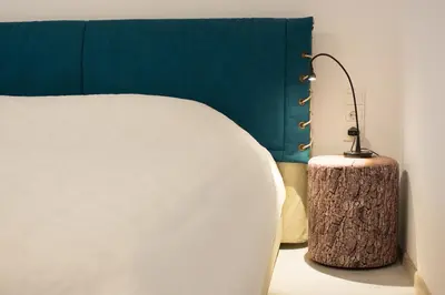 a bedroom with a bed and a lamp on a table at Snow apartment in Druskininkai