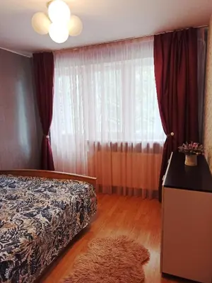 a bedroom with a bed and a window at Jaukus būstas poilsiui in Kaunas