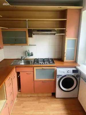 a kitchen with a stove and a washing machine at Jaukus būstas poilsiui in Kaunas