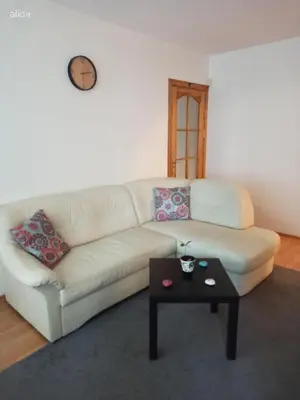 a living room with a white couch and a coffee table at Jaukus būstas poilsiui in Kaunas