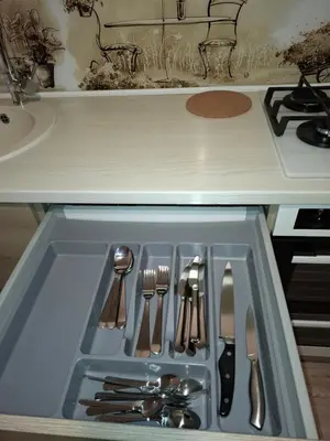 a drawer in a kitchen with utensils in it at Silver Vytauto Apartments in Šiauliai