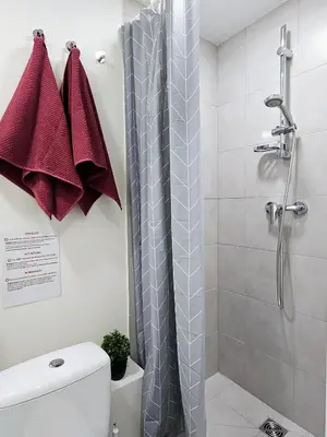 a bathroom with a shower and a toilet at Airport & Station Stay Vilnius in VNO