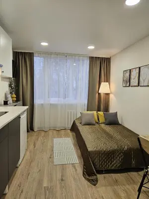 a bedroom with a bed and a large window at Airport & Station Stay Vilnius in VNO