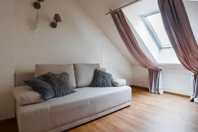 a couch in a living room with a window at St Michael's terrace in Vilnius