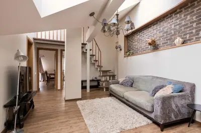 a living room with a couch and a brick wall at St Michael's terrace in Vilnius