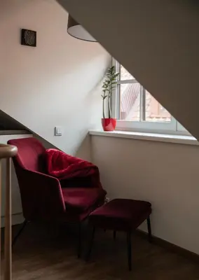 a living room with a chair and a window at St Michael's terrace in Vilnius