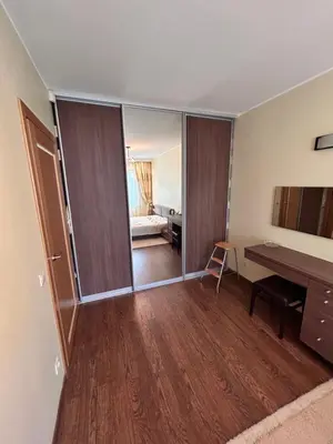 an empty room with a desk and a bedroom at Lina in Vilnius