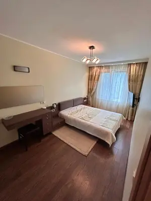 a bedroom with a bed and a desk in it at Lina in Vilnius
