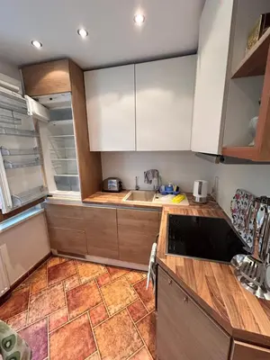 a kitchen with white cabinets and a counter top at Lina in Vilnius