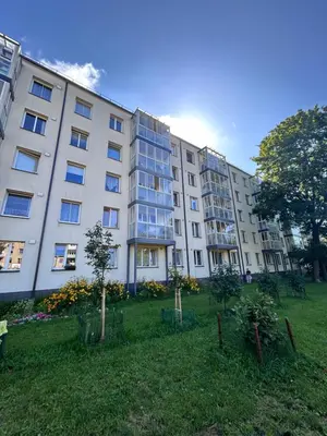 a large apartment building with a lawn in front of it at Lina in Vilnius