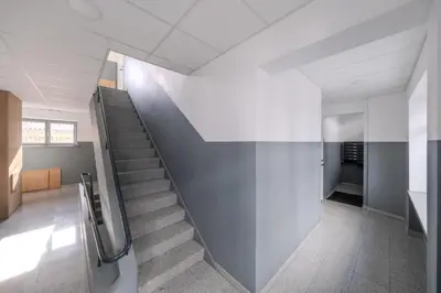 a staircase in a building with a stair case at Central Apartment in Kaunas with Free Parking in Kaunas