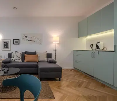 a living room with a couch and a chair at Central Apartment in Kaunas with Free Parking in Kaunas
