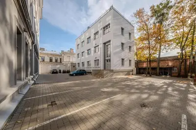 a white building with a car parked in front of it at Central Apartment in Kaunas with Free Parking in Kaunas