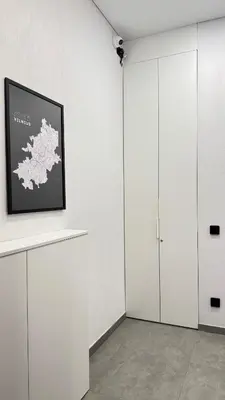 a white room with a picture of a map on a wall at Cosy Sopenas home in Vilnius
