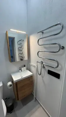 a bathroom with a shower and a sink and a mirror at Cosy Sopenas home in Vilnius