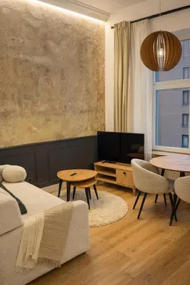 a living room with a bed and a table at Central Breeze Flat x Self Check-in in Vilnius