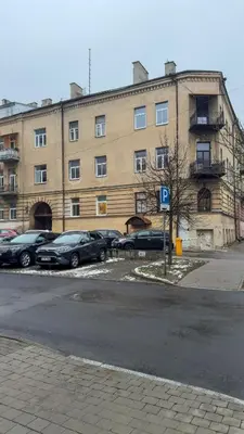 a large building with cars parked in a parking lot at Central Breeze Flat x Self Check-in in Vilnius