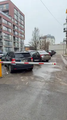 a line of cars parked in a parking lot at Central Breeze Flat x Self Check-in in Vilnius