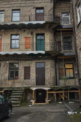 an old brick building with stairs and windows at Central Breeze Flat x Self Check-in in Vilnius