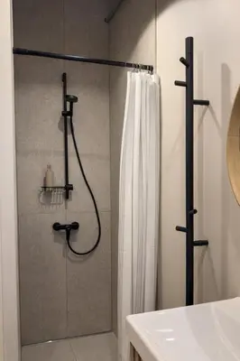 a bathroom with a shower with a shower curtain at Central Breeze Flat x Self Check-in in Vilnius