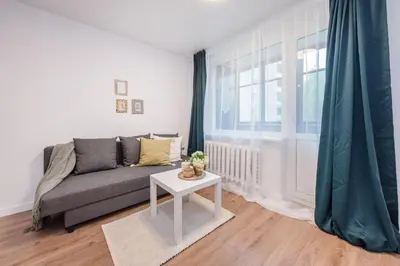 a living room with a couch and a table at 00Near Gates of Dawn Cozy bright 1 bedr in Vilnius