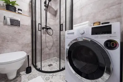 a washing machine in a bathroom with a toilet at 00Near Gates of Dawn Cozy bright 1 bedr in Vilnius