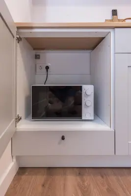 a microwave sitting on a shelf in a kitchen at 00Near Gates of Dawn Cozy bright 1 bedr in Vilnius
