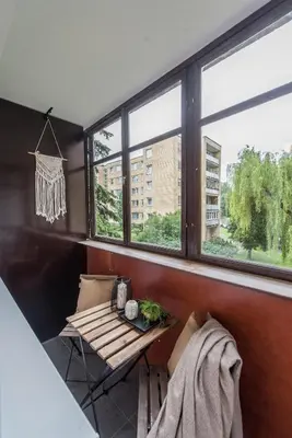 a room with a table and some windows at 00Near Gates of Dawn Cozy bright 1 bedr in Vilnius