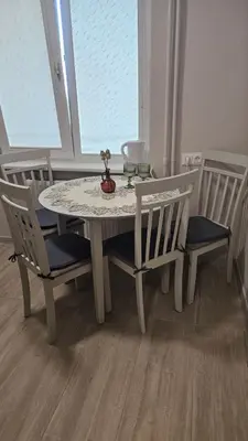 a white table and chairs with a table and a window at Kambarių nuoma Kaune Taikos pr in Kaunas