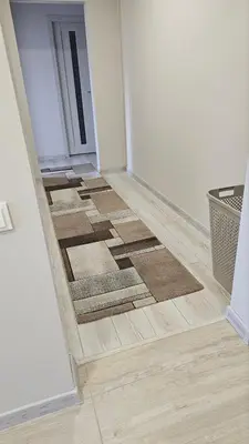 a hallway with a rug on the floor next to a door at Kambarių nuoma Kaune Taikos pr in Kaunas
