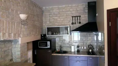 a small kitchen with a microwave and a stove at Apartamentai Vilnius Užupis in Vilnius
